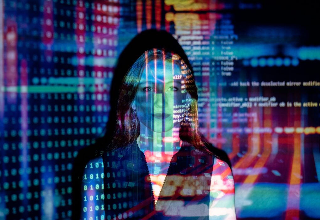 A woman with digital code projections on her face, representing technology and future concepts.